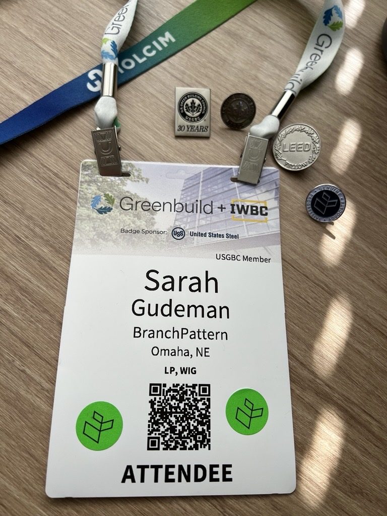 Greenbuild and IWBC attendee badge for Sarah Gudeman, with USGBC and LEED Fellow pins beside it